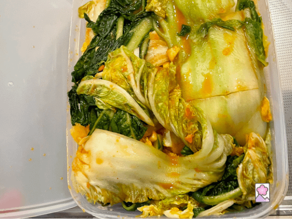 Kimchi in an airtight container ready to be sealed for fermenting