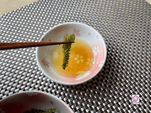 Sea grapes dipped in dressing in a bowl
