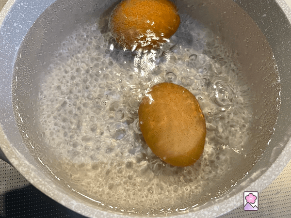 2 eggs boiling in water