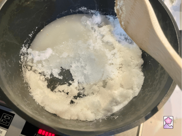 Sugar and lemon juice in a large saucepan being dissolved