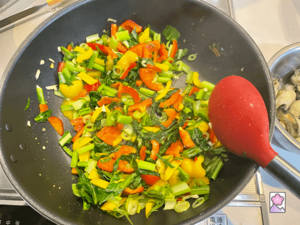 Stir frying vegetables and spices in a large skillet