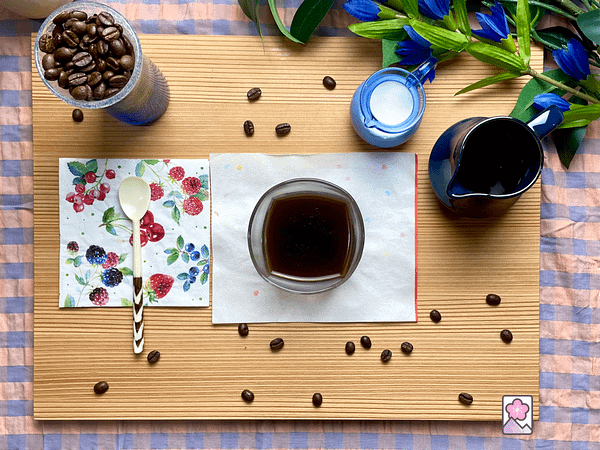 Japanese Sweet Coffe Jelly served on a wooden tray with cream and chocolate syrup in nearby pitchers