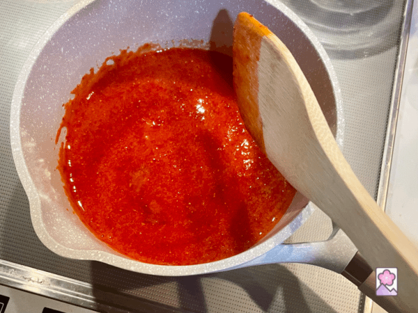 Cooking up strawberry puree in a saucepan