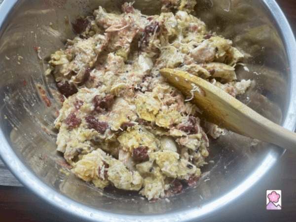Leftover Turkey and stuffing in a mixing bowl combined with a wooden spoon