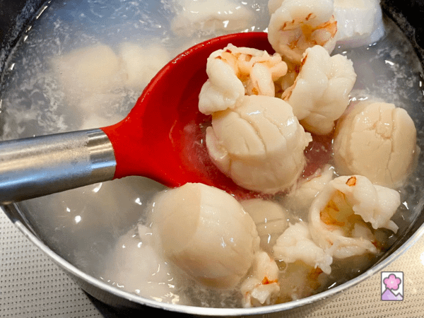 Fresh shrimp and scallop are lightly boiled in salted water and lifted out with a slotted spoon