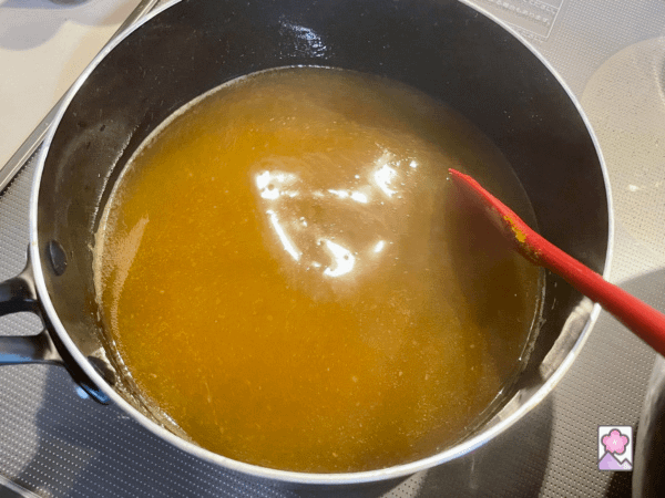 Curry gravy thickening in a pan while being stirred