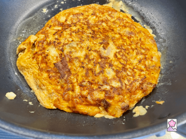 A cooked Egg Foo Young omelette in a skillet