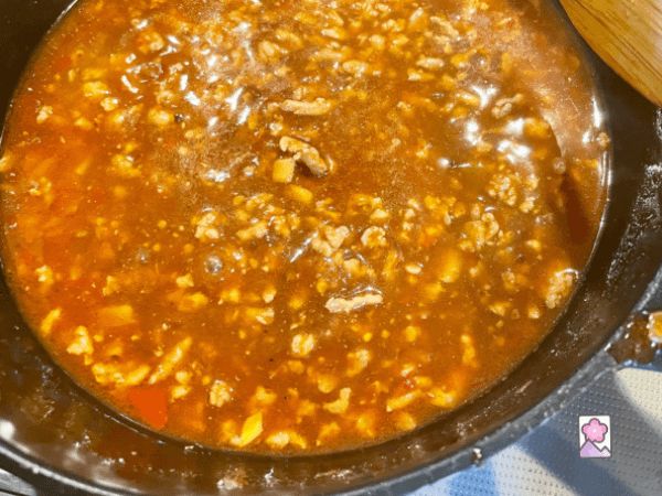 Chicken broth has been added to the meat and needs to simmer for 5 to 7 minutes