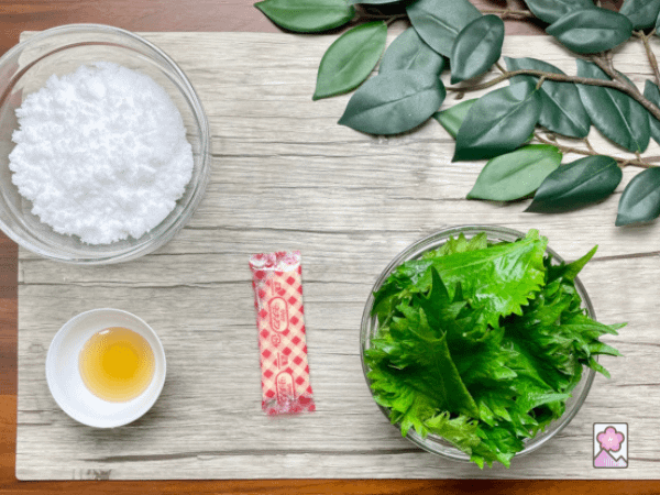 Ingredients for Refreshing Shiso jelly lined up on a board- Shiso leaves, gelatin, lemon juice and sugar