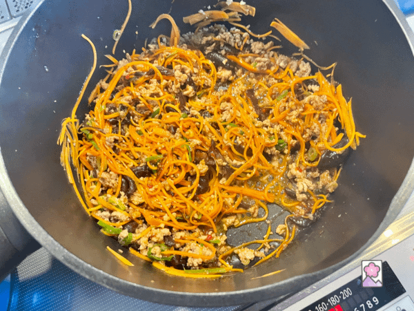 Pork and Veggies with aromatic ingredients sautees in a stockpot