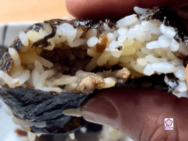 Someone bit into a savory Onigiri stuffed with Italian sausage