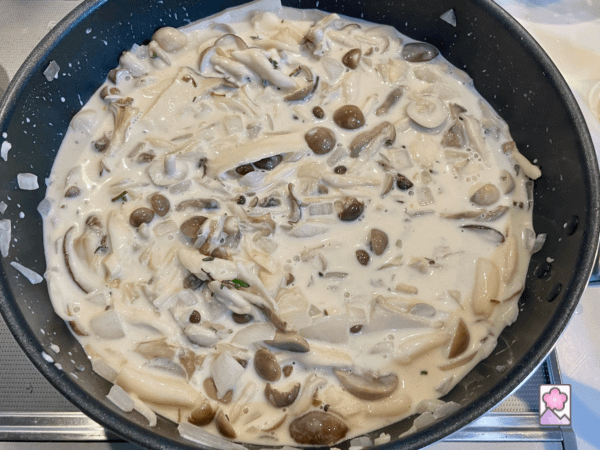 The cream and herbs simmer with the mushrooms over a skillet