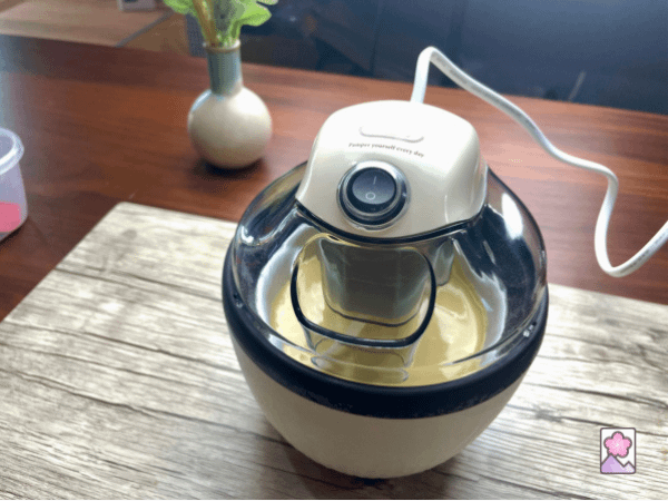 A simple electric ice cream maker churning a batch of vanilla ice cream