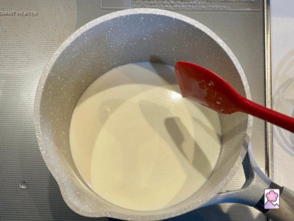 Cooking Panna cotta over a low heat in a saucepan and stirring