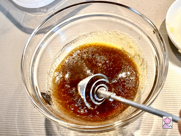 Whisking ingredients in a bowl to make the Soy Dressing