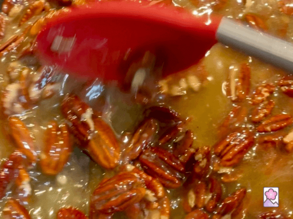 Mixing pecans into caramel