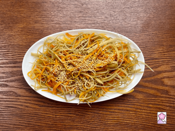 Kinpira Gobo in an oval ceramic dish on wood