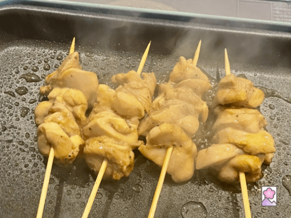 Cooking chicken skewers on a skillet The juicy chicken looks delicious.