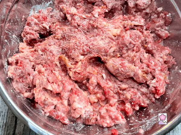 Bologna meat mixture in a metal bowl