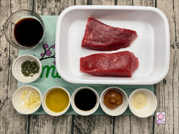 Ingredients of Tender Japanese Roast Beef Stips laid out on a board