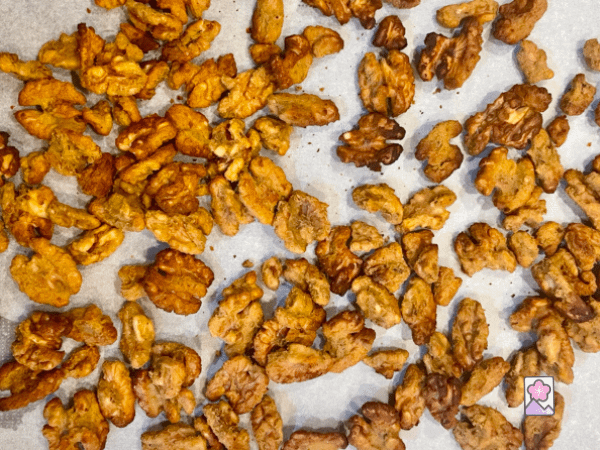 Wasabi Coated Walnuts cool on a sheet of Parchment Paper