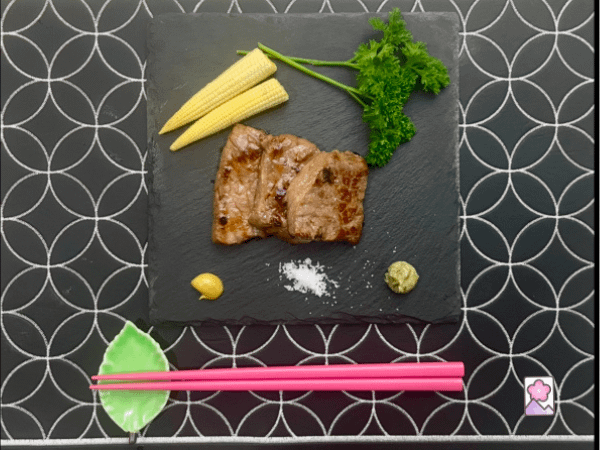 Delicious and Tender Japanese Roast Beef strips served on a plate with condiments