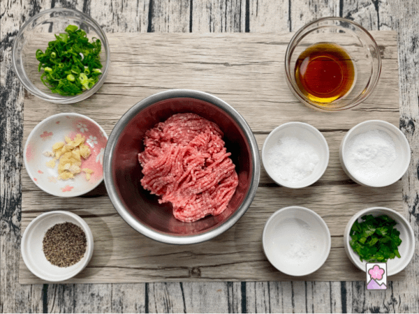 A plethora of ingredients are used to flavor zesty Vietnamese meatballs. Here they are laid out on an ingredient board.