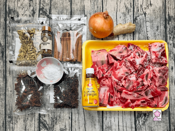 Ingredients for Pho Broth include beef bones, onion, ginger, salt, and plenty of aromatics - here they are all laid out on a table
