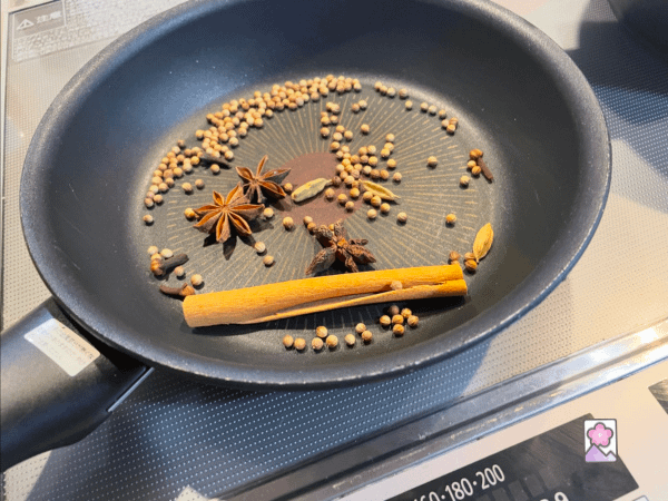 Star Anise, Cardamom Pods, Corriander Seeds, Cloves and a cinnamon stick are gently warmed in a pan