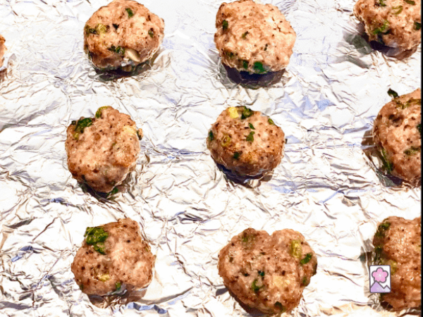 Meatball coming out of the oven on a cooking sheet