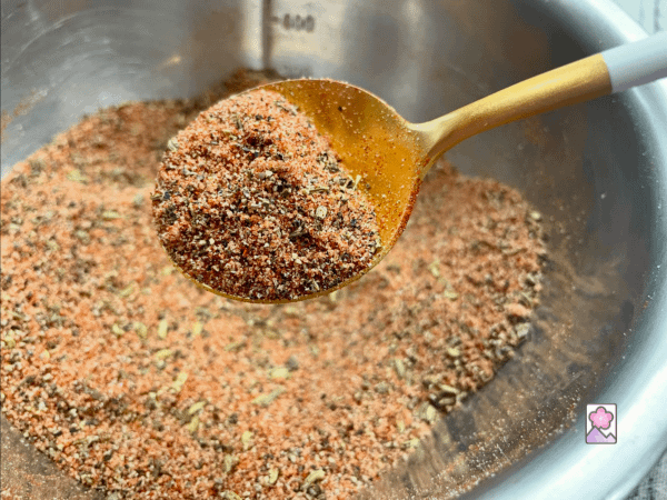 Sweet Italian sausage spice mix on a golden spoon
