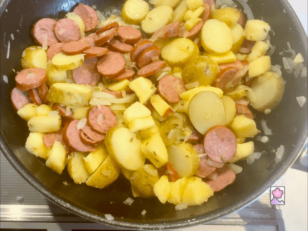 Apples, potatoes and fennel seed are added to the kielbasa in the skillet
