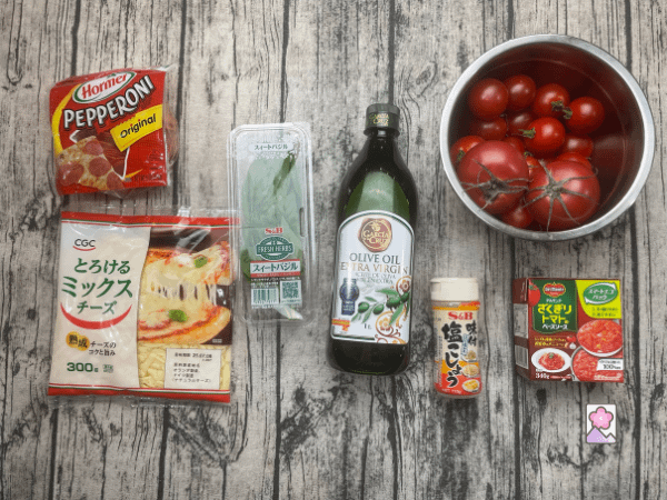 Ingredients for Sicilian Pepperoni Pizza laid out on a board