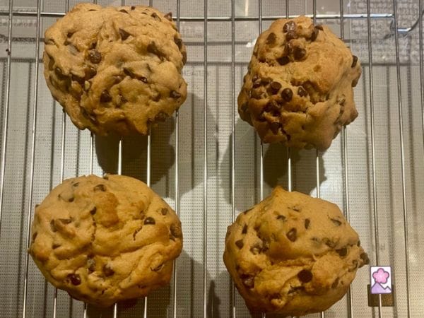 Bakery Style Chocolate Chip Cookies are cooling on a rack.