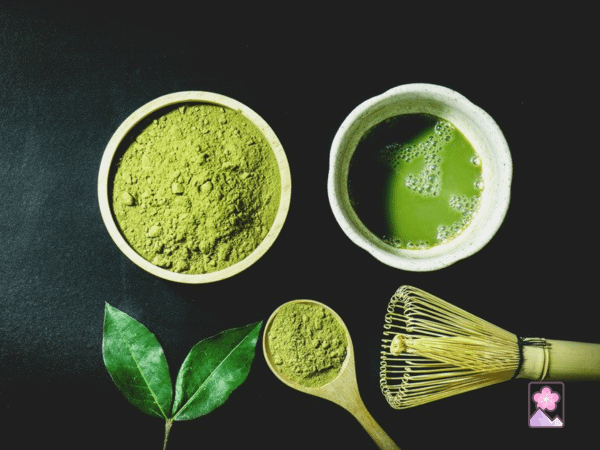 matcha: powdered green tea, frothy matcha drink, and a bamboo whisk