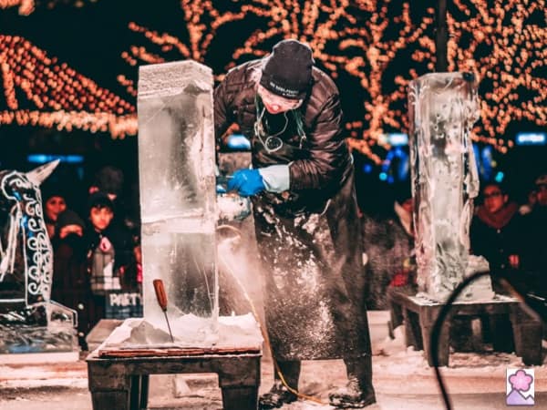 An ice carver creating a sculpture at the Sapporo Snow Festival