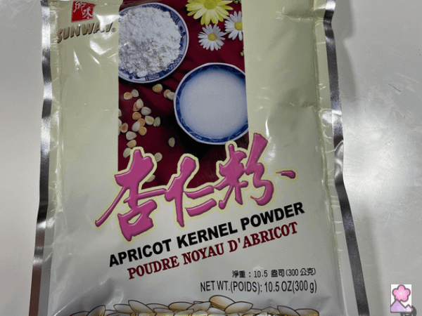A package of powdered apricot kernel on a white table