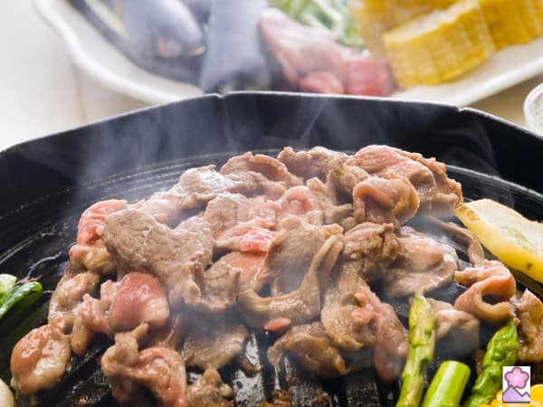 Mutton grilling on a black hot plate