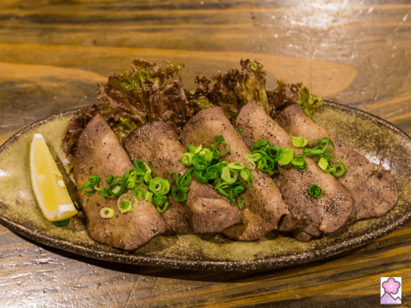 Grilled beef tongue on a ceramic plate