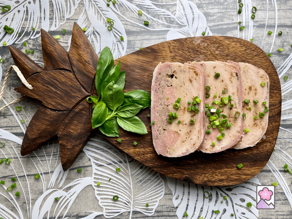Slow cooker chicken and pork terrine slices in a pineapple shaped wooden cutting board
