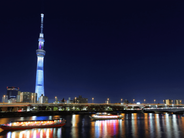 A view from the Sumida River at night with Tokyo Skytree in the background