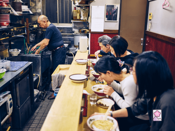 A Tokyo ramen shop with people eating at a counter