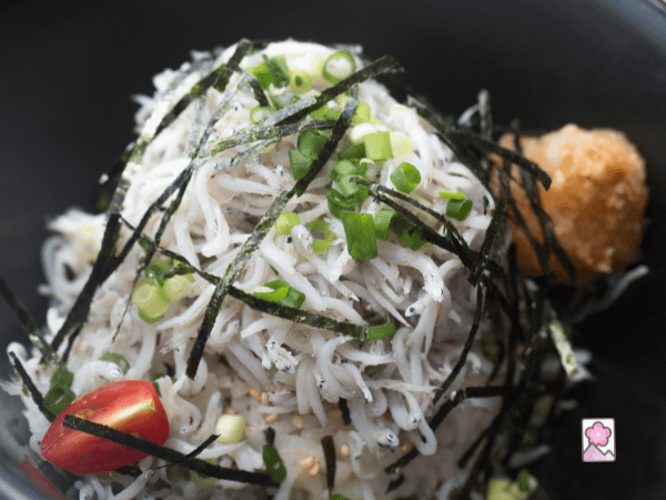 Whitebait in a bowl topped with nori strips