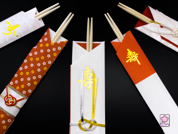 Iwai bashi - New Years chopsticks arranged in a semicircular pattern each in a decorative sleeve