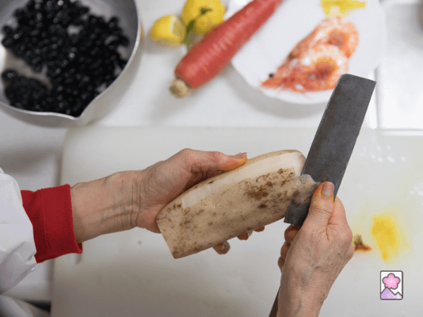Osechi ryori preparation contains a lot of vegetables – so a nakiri knife is being used to peel a lotus root