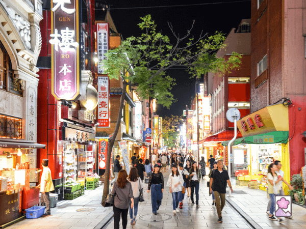 The streets of Chinatown in the evening as people walk down the street