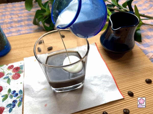 Pouring cream onto coffee jelly