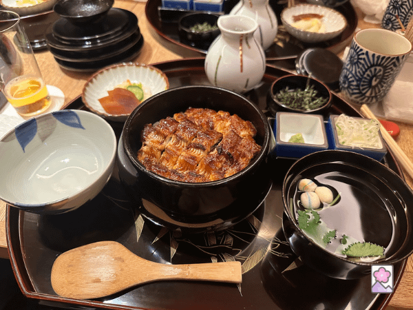Hitsumabushi is a multi course meal featuring broiled eel. This lovely dish is served on a tray.