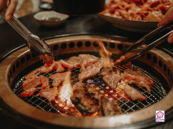 Cooking meat on a tabletop grille at a yakiniku restaurant 