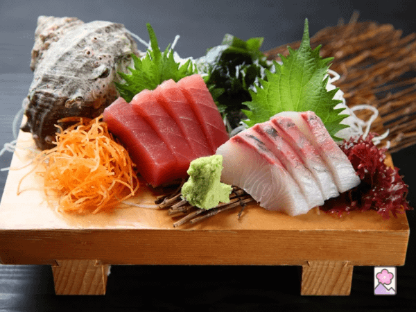 Nagashimori- sashimi is cut into flowing waves and served on a wood board